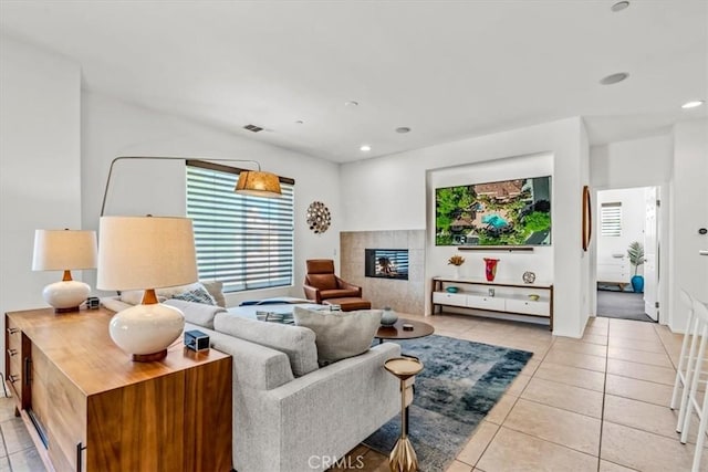 living room featuring light tile patterned floors and a tile fireplace