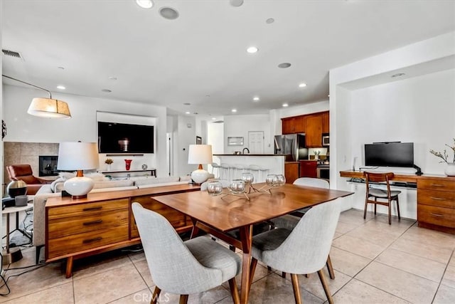 tiled dining area featuring a fireplace