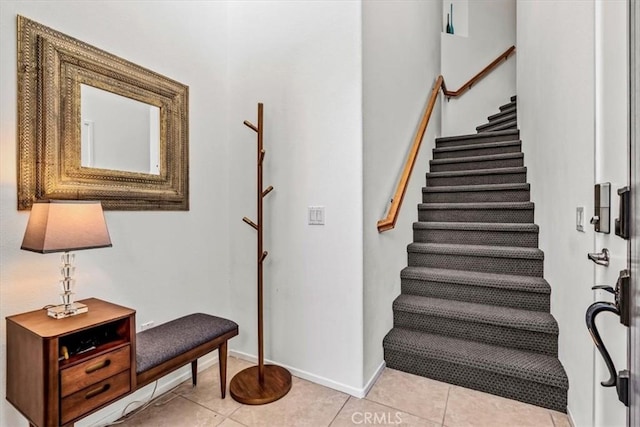 staircase featuring tile patterned floors