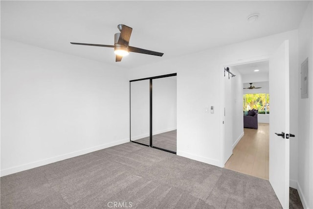 unfurnished bedroom featuring a closet, ceiling fan, and light colored carpet