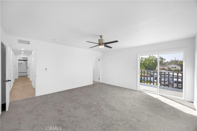 carpeted empty room featuring ceiling fan