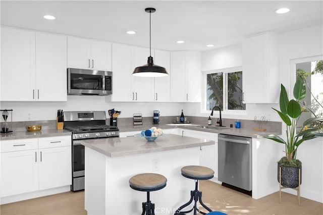 kitchen featuring pendant lighting, stainless steel appliances, a healthy amount of sunlight, and sink