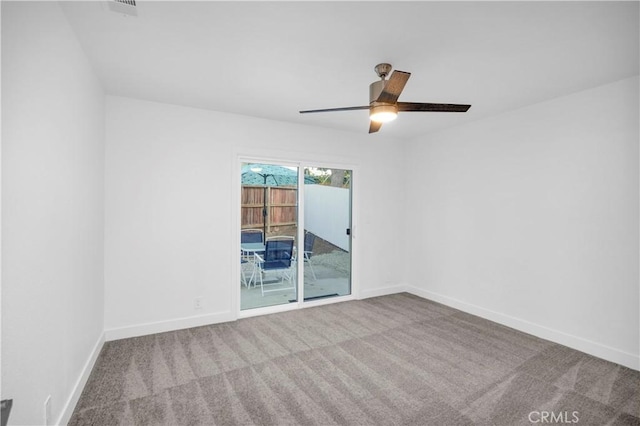 spare room featuring light carpet and ceiling fan