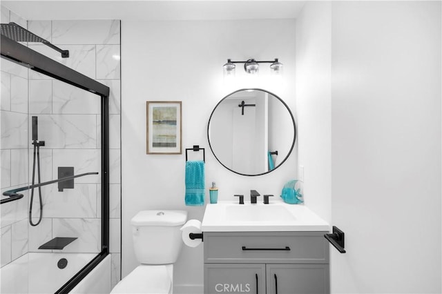 full bathroom featuring vanity, toilet, and bath / shower combo with glass door