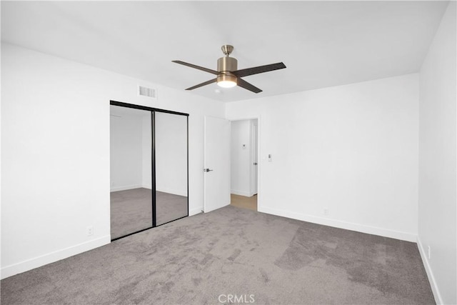 unfurnished bedroom featuring carpet flooring, ceiling fan, and a closet