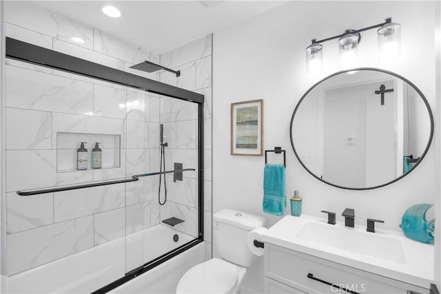 full bathroom with vanity, toilet, and shower / bath combination with glass door