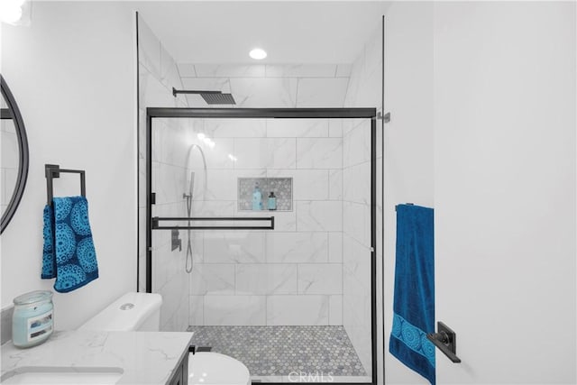 bathroom featuring vanity, an enclosed shower, and toilet