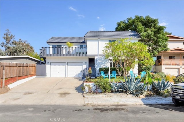 view of front of property with a balcony and a garage