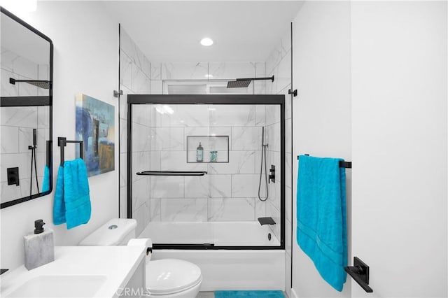 full bathroom with vanity, toilet, and bath / shower combo with glass door