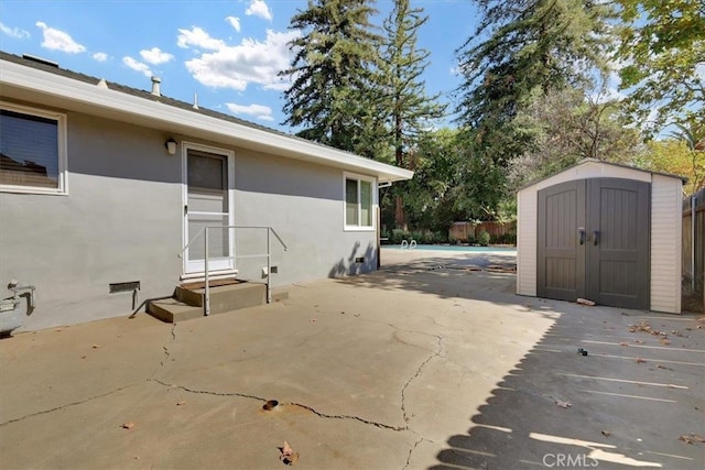 view of patio featuring a storage unit