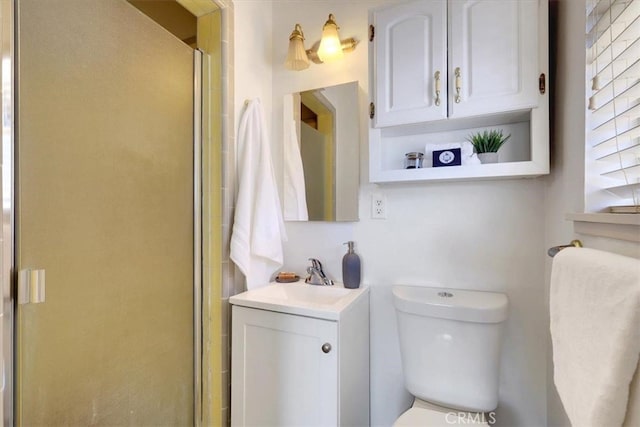 bathroom with walk in shower, vanity, and toilet