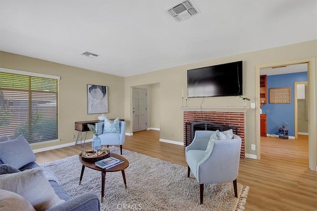 living room featuring a fireplace and light hardwood / wood-style floors