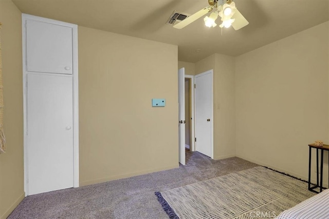 unfurnished bedroom featuring light carpet and ceiling fan