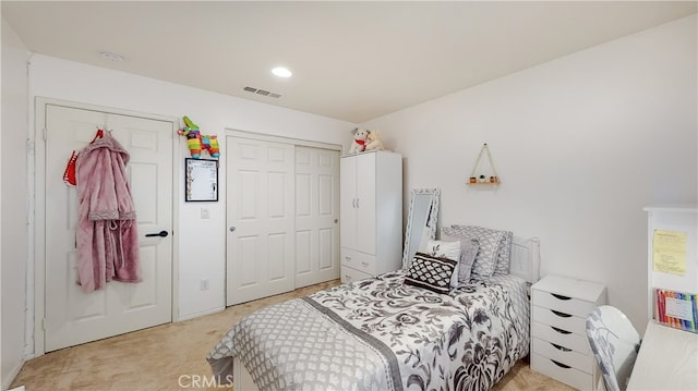 bedroom featuring light carpet and a closet