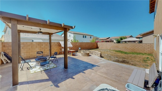 view of patio / terrace featuring ceiling fan and a fire pit