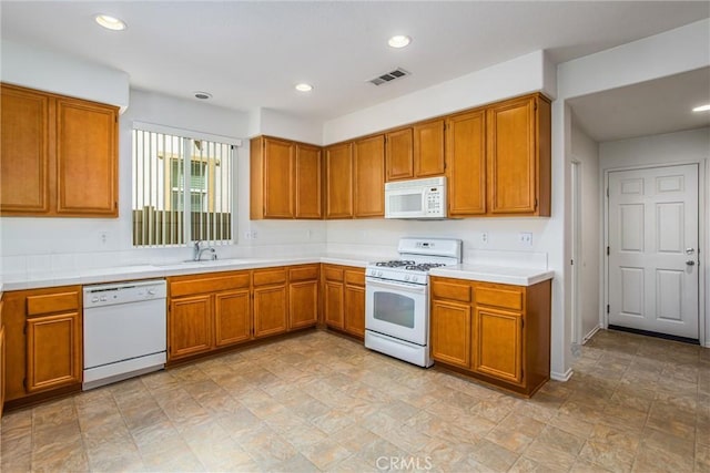 35375 Trevino Trl, Beaumont, CA 92223 - kitchen with white appliances, a sink, brown cabinetry, light countertops, and recessed lighting