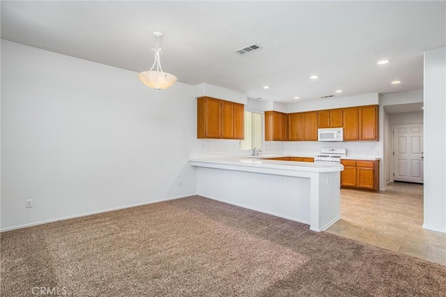 kitchen featuring kitchen peninsula, light carpet, white appliances, sink, and pendant lighting