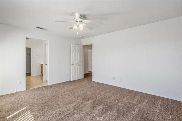 unfurnished room with ceiling fan and carpet floors