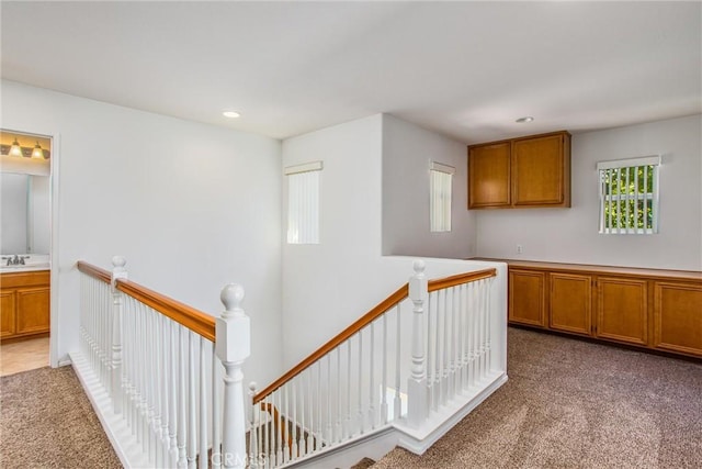 hallway featuring carpet flooring and sink