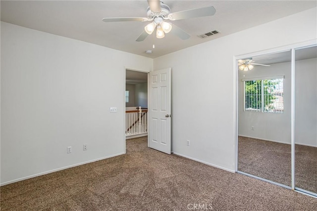 unfurnished bedroom with carpet floors, a closet, and ceiling fan