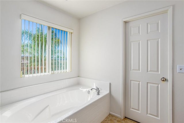 bathroom featuring tiled bath