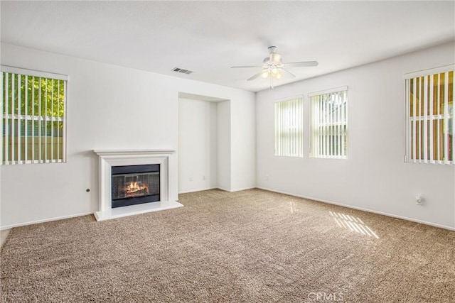 35375 Trevino Trl, Beaumont, CA 92223 - unfurnished living room with ceiling fan, carpet, a glass covered fireplace, and baseboards