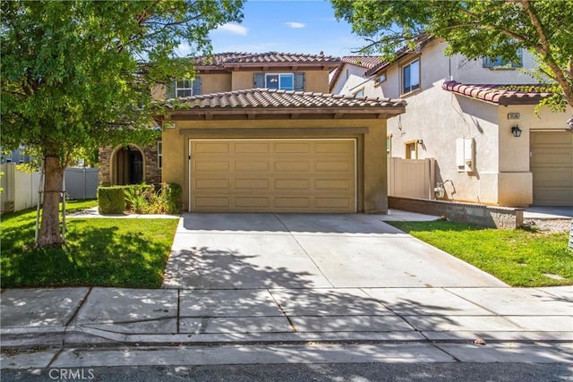 mediterranean / spanish-style house featuring a front lawn and a garage