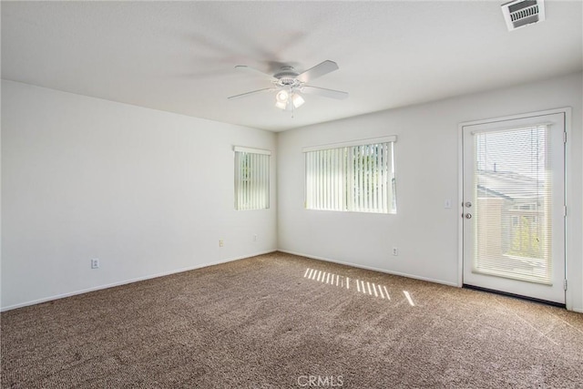 carpeted spare room with ceiling fan