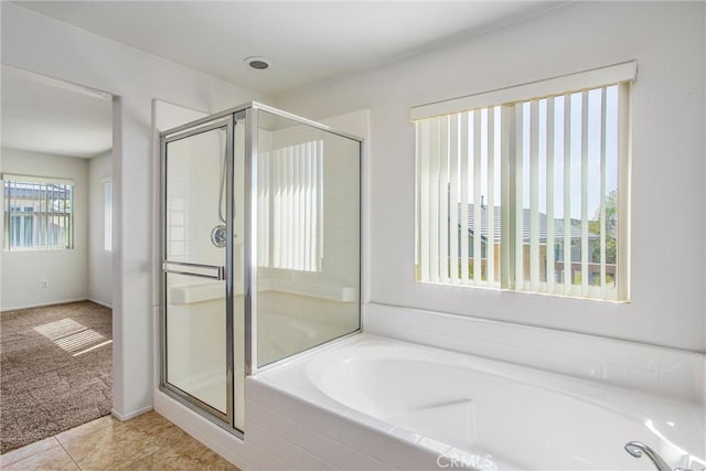 bathroom featuring tile patterned flooring, plus walk in shower, and a healthy amount of sunlight