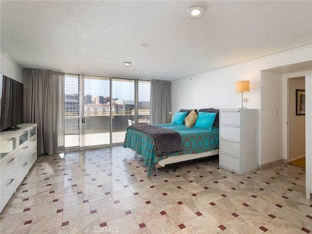 bedroom with access to exterior and a textured ceiling