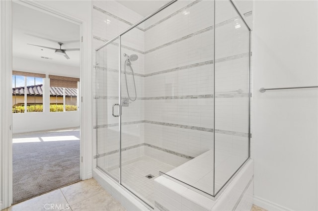 bathroom featuring ceiling fan, an enclosed shower, and tile patterned floors