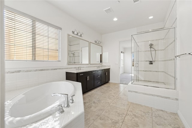 bathroom featuring tile patterned floors, vanity, and separate shower and tub