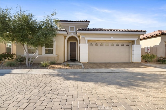 mediterranean / spanish house featuring a garage