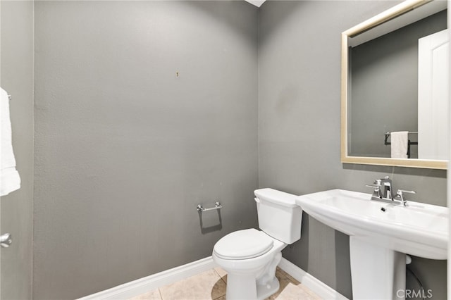 bathroom featuring tile patterned flooring, sink, and toilet