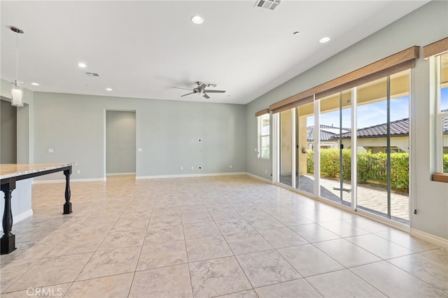 empty room with light tile patterned floors and ceiling fan