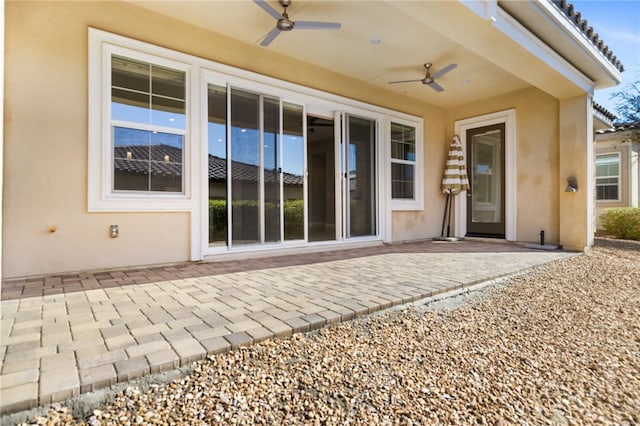 exterior space with ceiling fan and a patio area