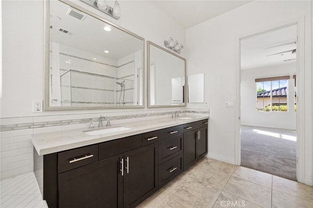 bathroom with vanity, tile patterned floors, and tiled shower