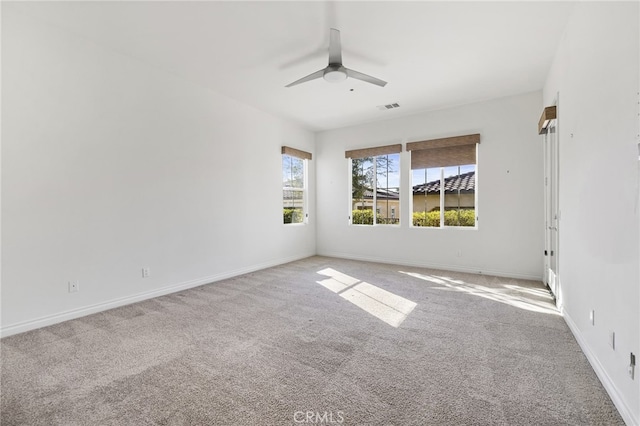 carpeted empty room featuring ceiling fan