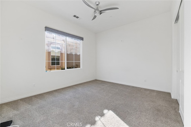 unfurnished room with ceiling fan and carpet flooring