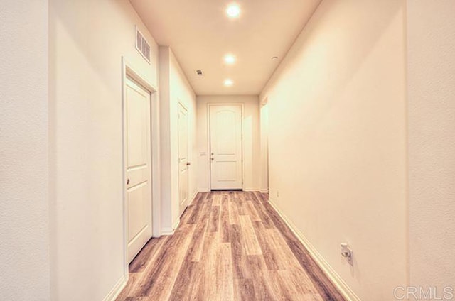 corridor featuring hardwood / wood-style floors