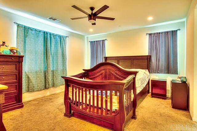 bedroom featuring ceiling fan and light colored carpet