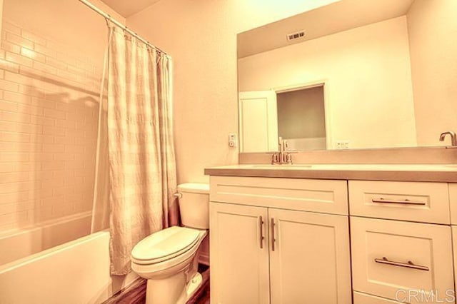 full bathroom featuring shower / bath combination with curtain, vanity, and toilet