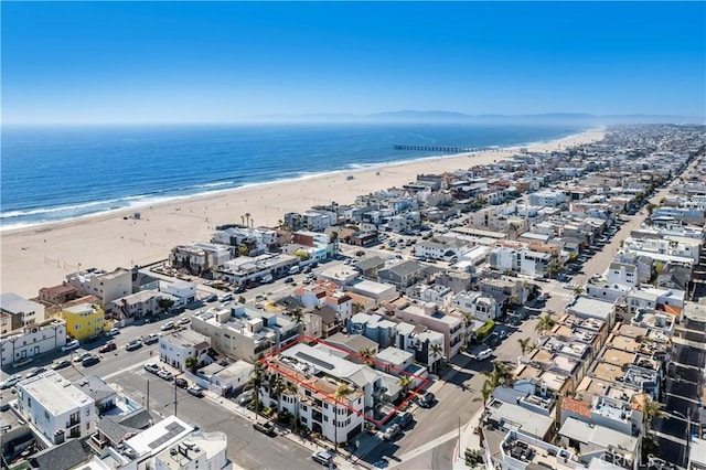 drone / aerial view with a water view and a beach view