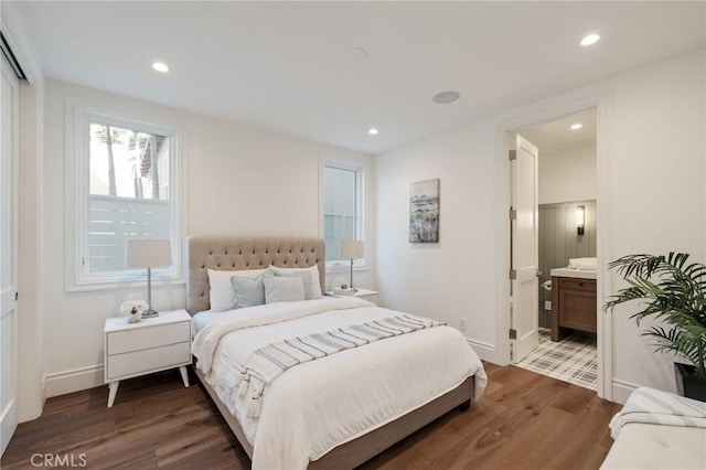 bedroom with dark wood-type flooring and ensuite bathroom