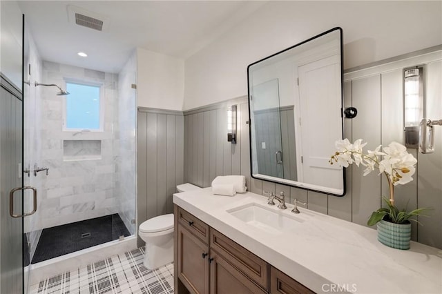 bathroom with vanity, toilet, and a shower with shower door