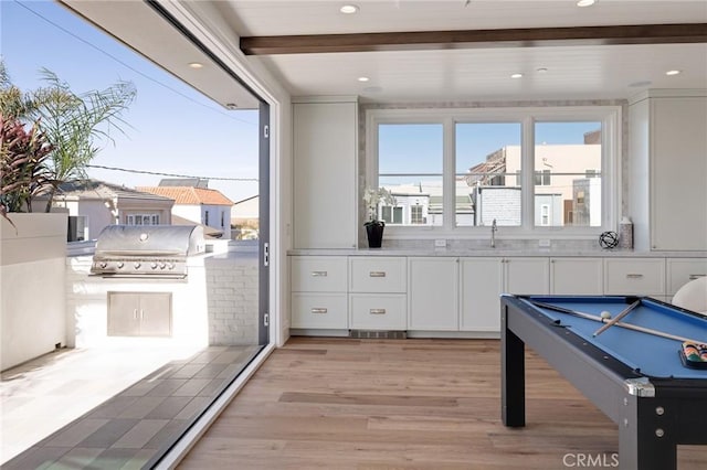 game room with sink, beam ceiling, billiards, and light wood-type flooring