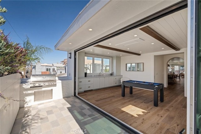 playroom with beam ceiling, pool table, and light hardwood / wood-style floors