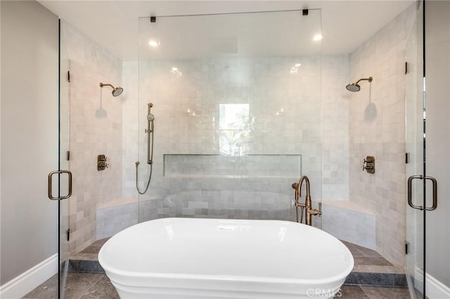 bathroom featuring shower with separate bathtub