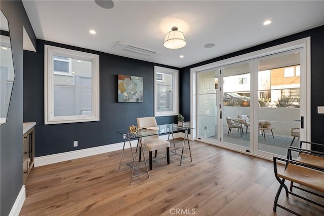 interior space with expansive windows and light wood-type flooring