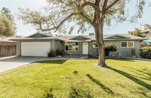 ranch-style house featuring a front yard and a garage